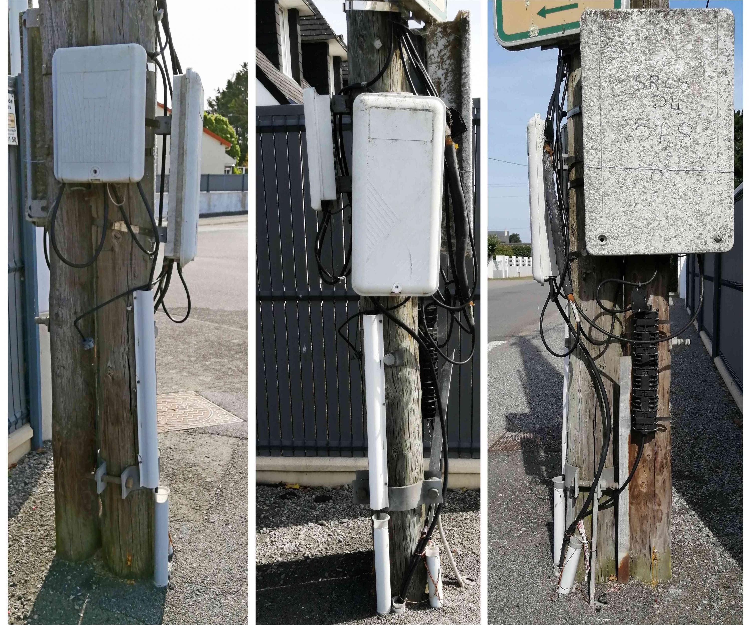 Trois boitiers de sous-répartition du réseau téléphonique sur un même poteau et transition aéro-souterraine